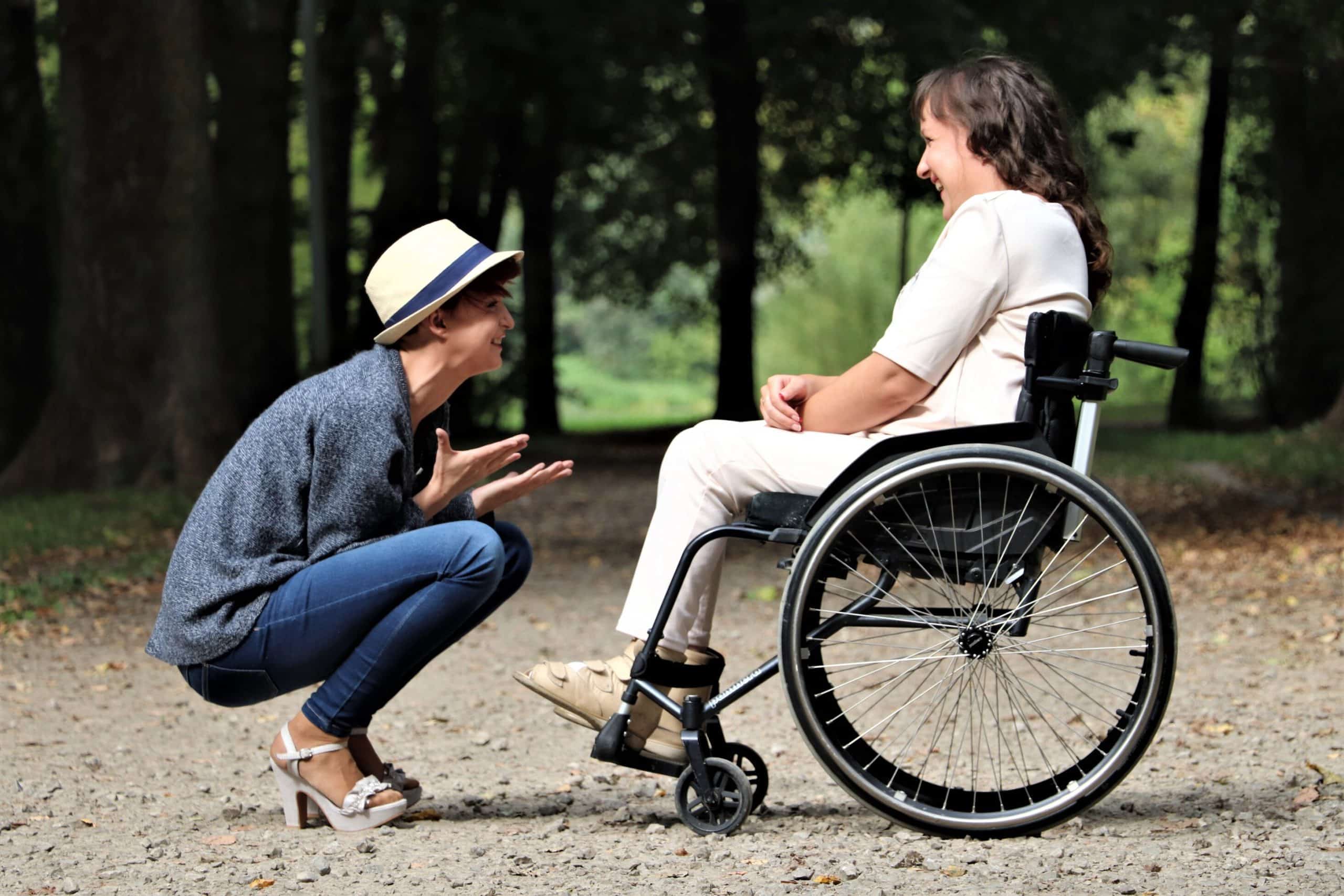 counselling for carers A man with a hat on crouched down looking at a lady in a wheelchair. He is explains how counselling for carers has helped him.